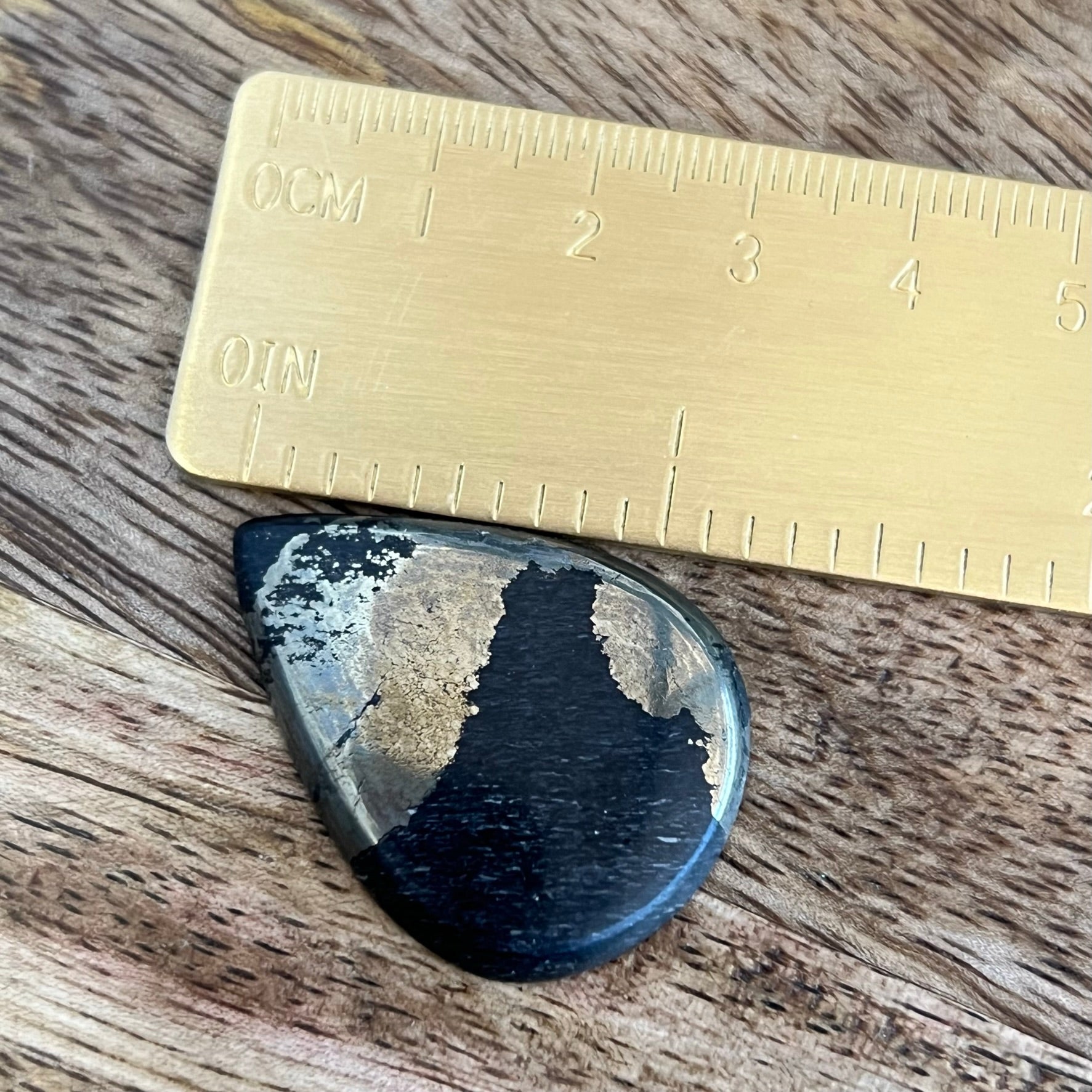 a piece of metal sitting on top of a wooden table