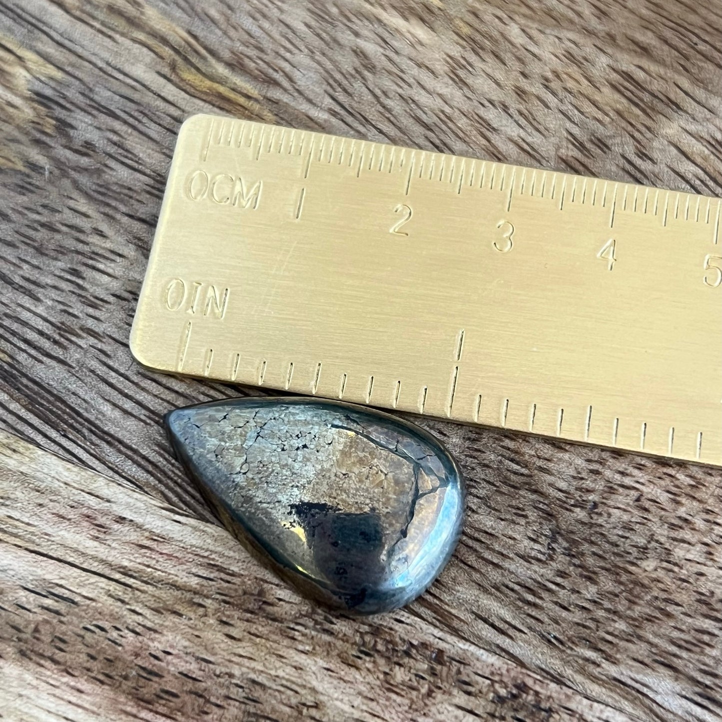 a piece of metal sitting on top of a wooden table