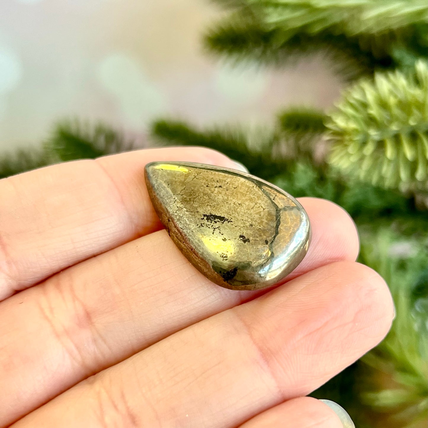 a person holding a piece of gold in their hand