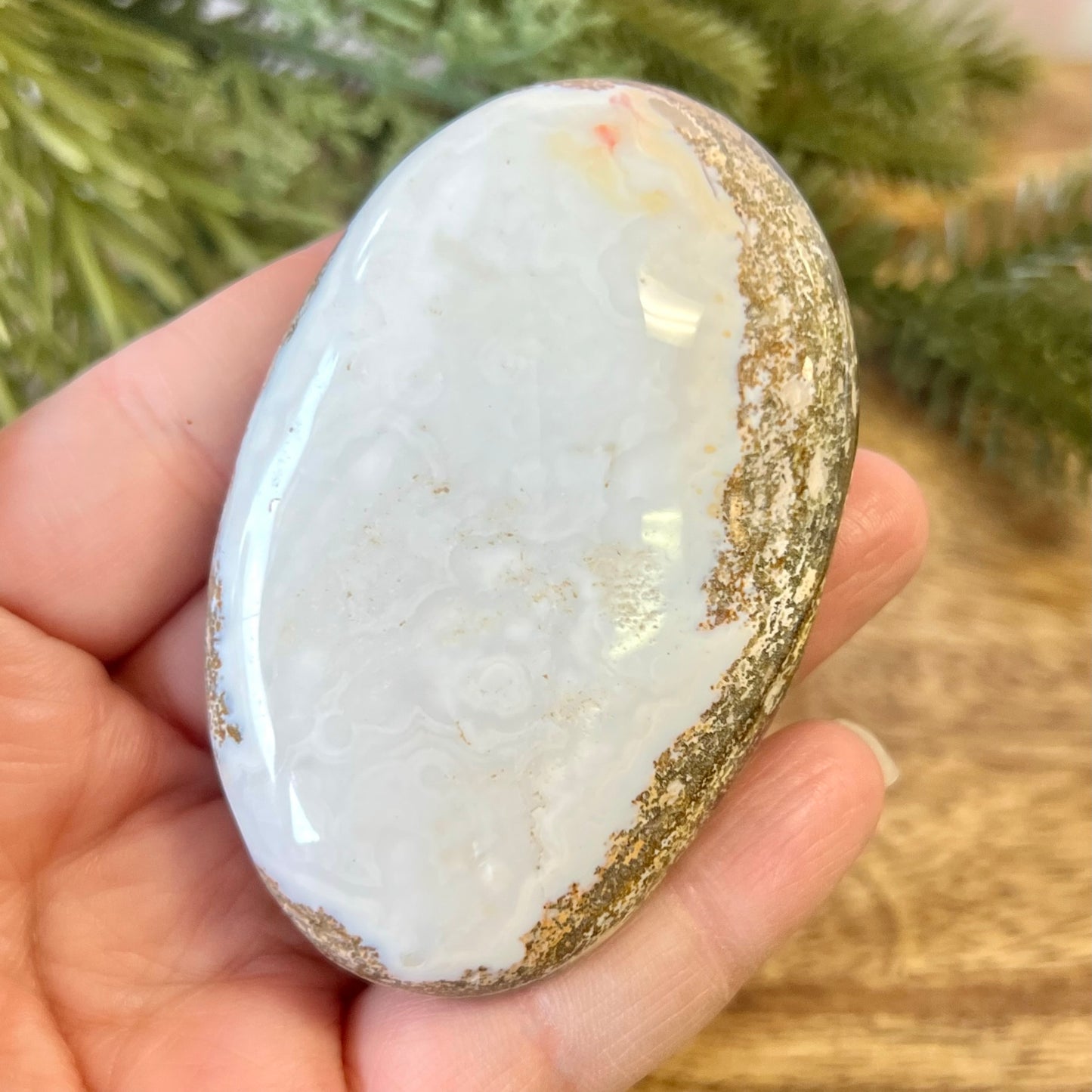 a person holding a large white rock in their hand