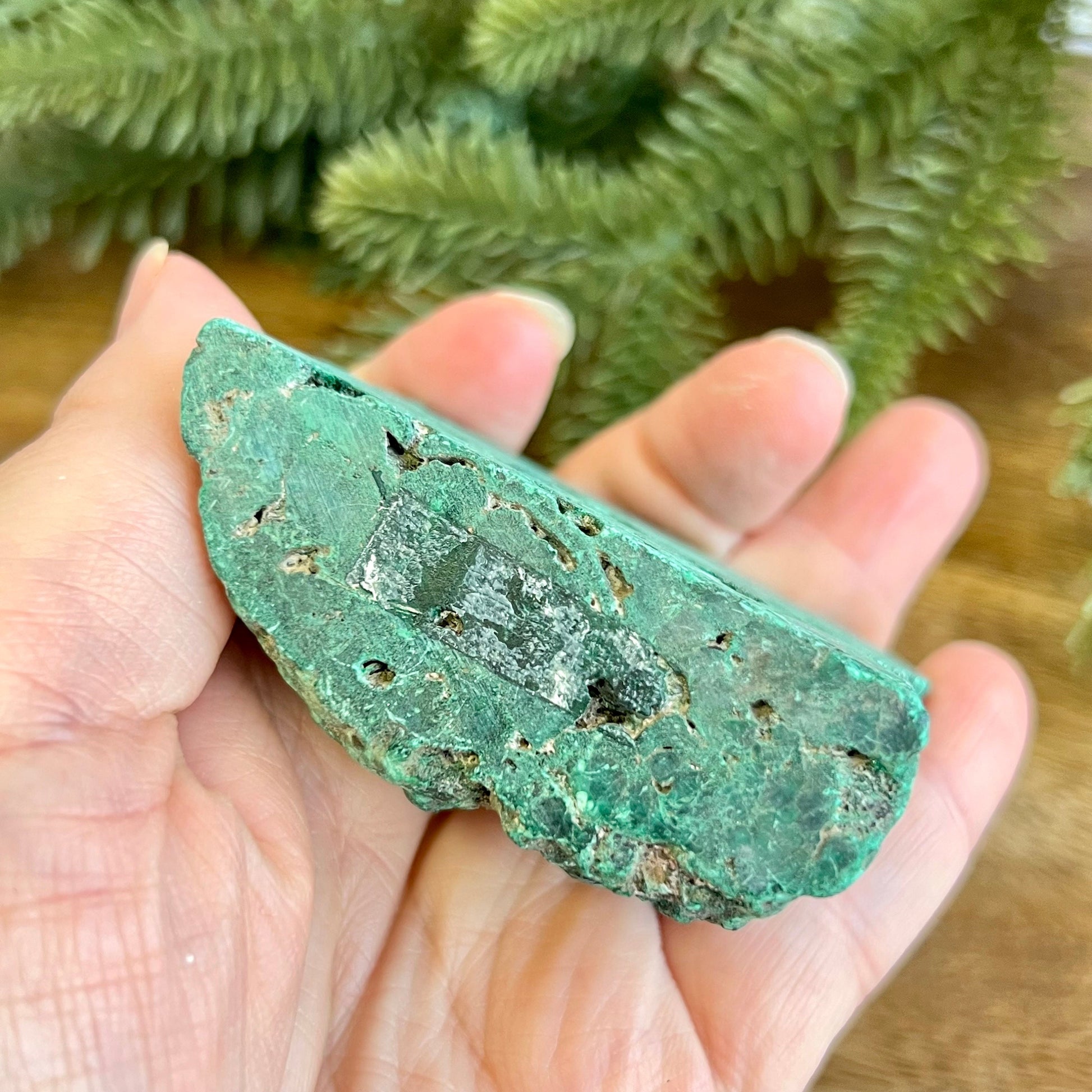 Cut slab of Malachite. Unpolished with a frosted finish. The back is natural and raw.