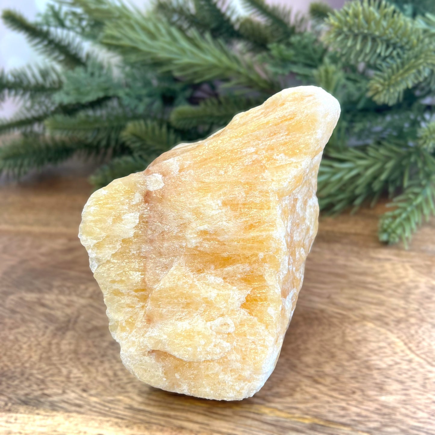 Image of a large, rough chunk piece of yellow Calcite crystal from Mexico. Very sunny color with a darker band. Rough on all edges, with a cylinder cut out on one side.
