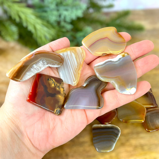 a person holding a bunch of glass pieces in their hand