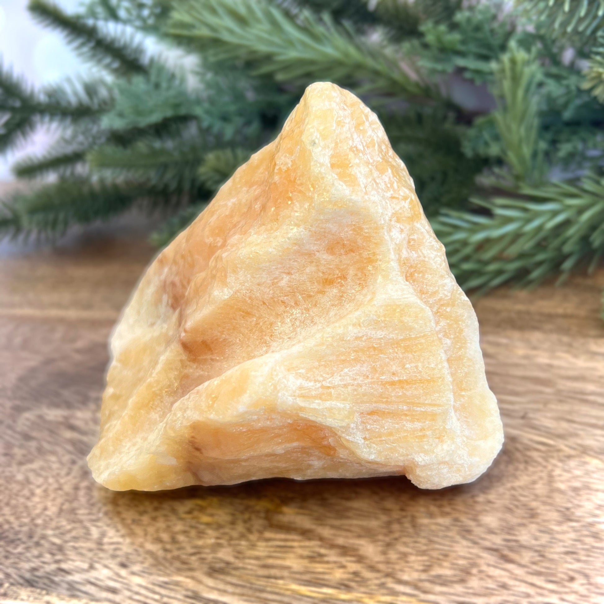 Image of a large, rough chunk piece of yellow Calcite crystal from Mexico. Very sunny color with a darker band. Rough on all edges, with a cylinder cut out on one side.