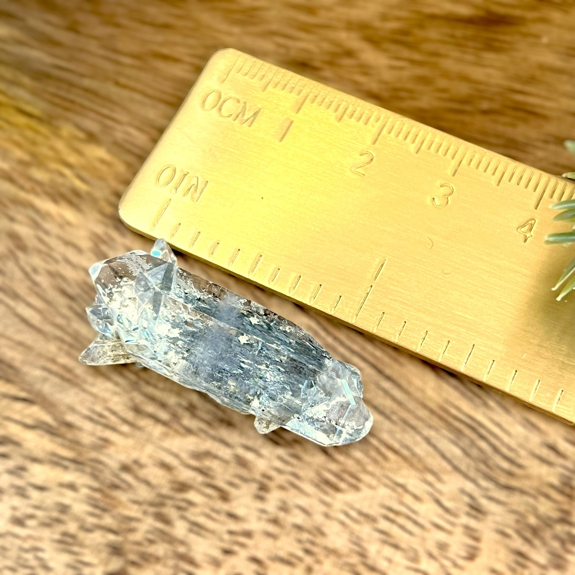 Close up of a small garden Quartz crystal point with chlorite inclusions. This mineral specimen is also called Lodolite, and is natural.