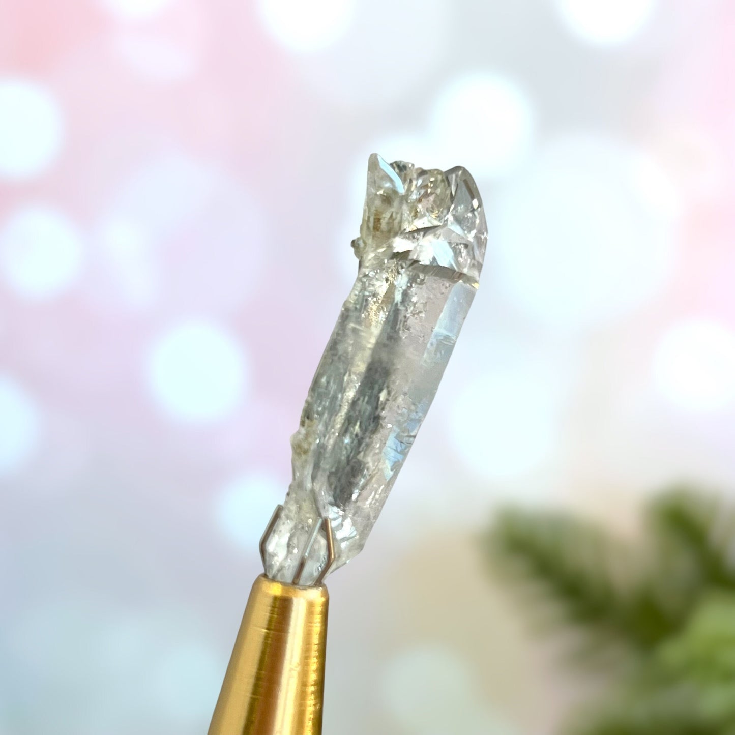 Close up of a small garden Quartz crystal point with chlorite inclusions. This mineral specimen is also called Lodolite, and is natural.