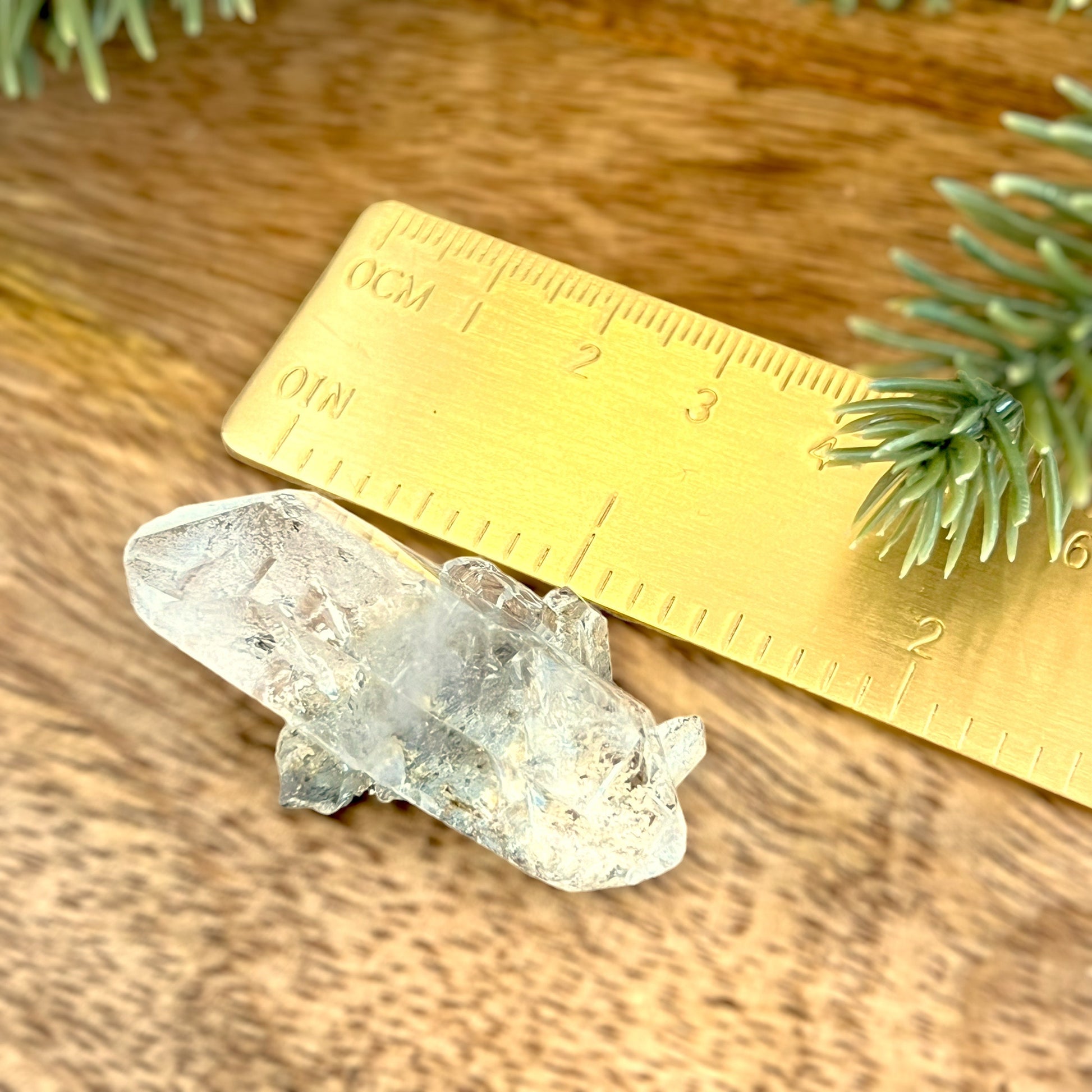 Close up of a small garden Quartz crystal point with chlorite inclusions. This mineral specimen is also called Lodolite, and is natural.