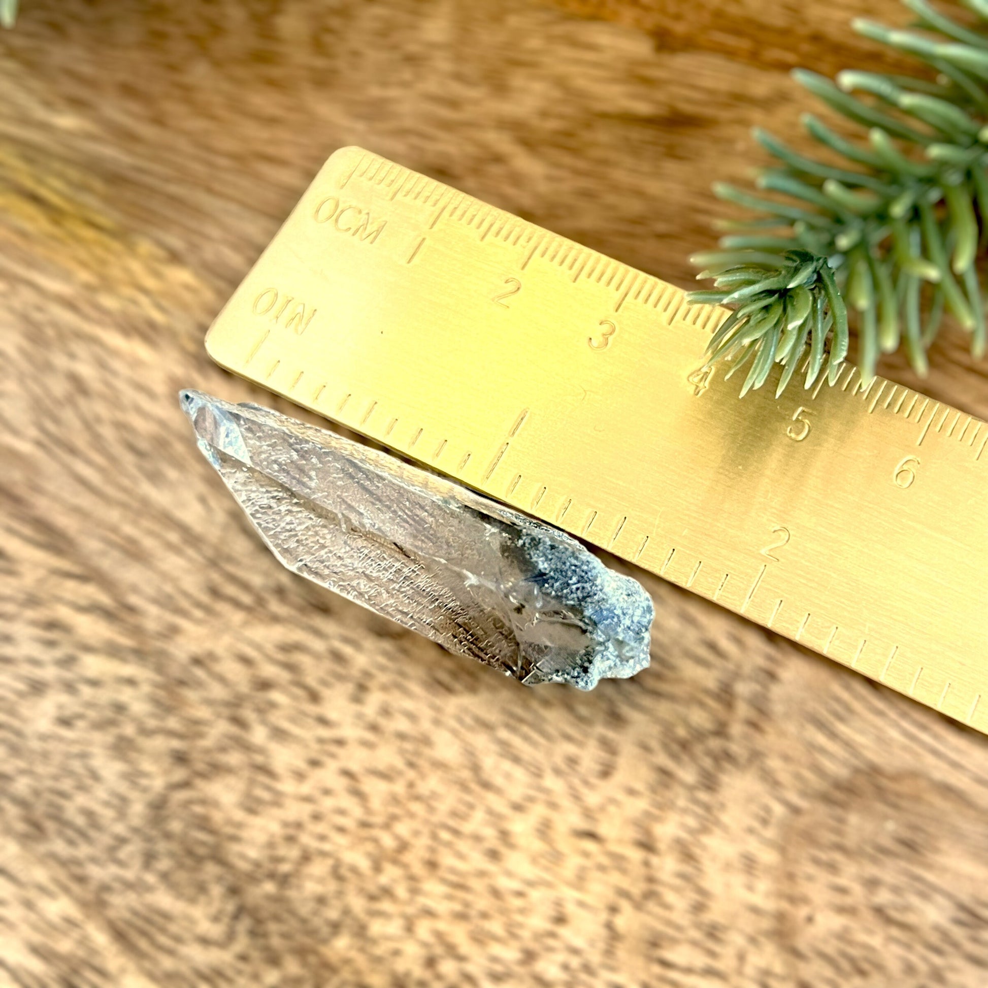 Close up of a small garden Quartz crystal point with chlorite inclusions. This mineral specimen is also called Lodolite, and is natural.