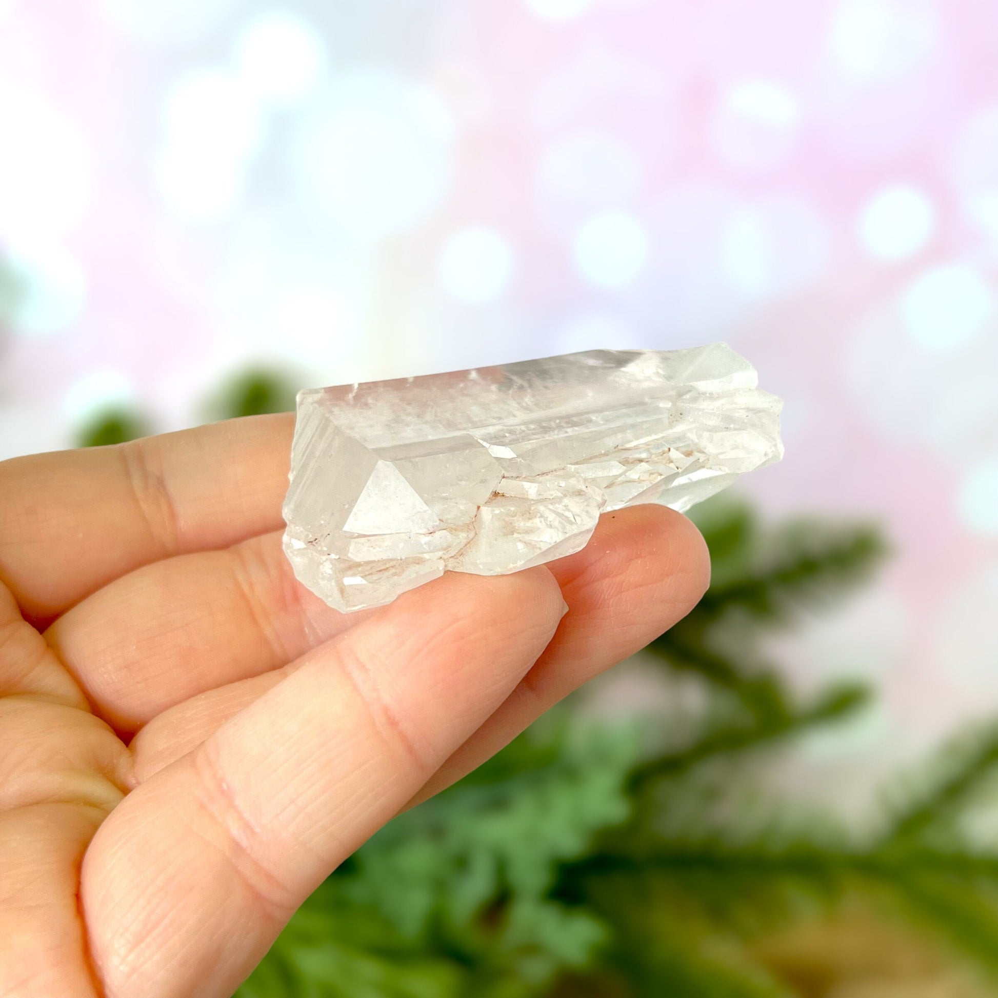 Close up of a Colombian clear Quartz crystal. It is very clear and has Lemurian horizontal lines.