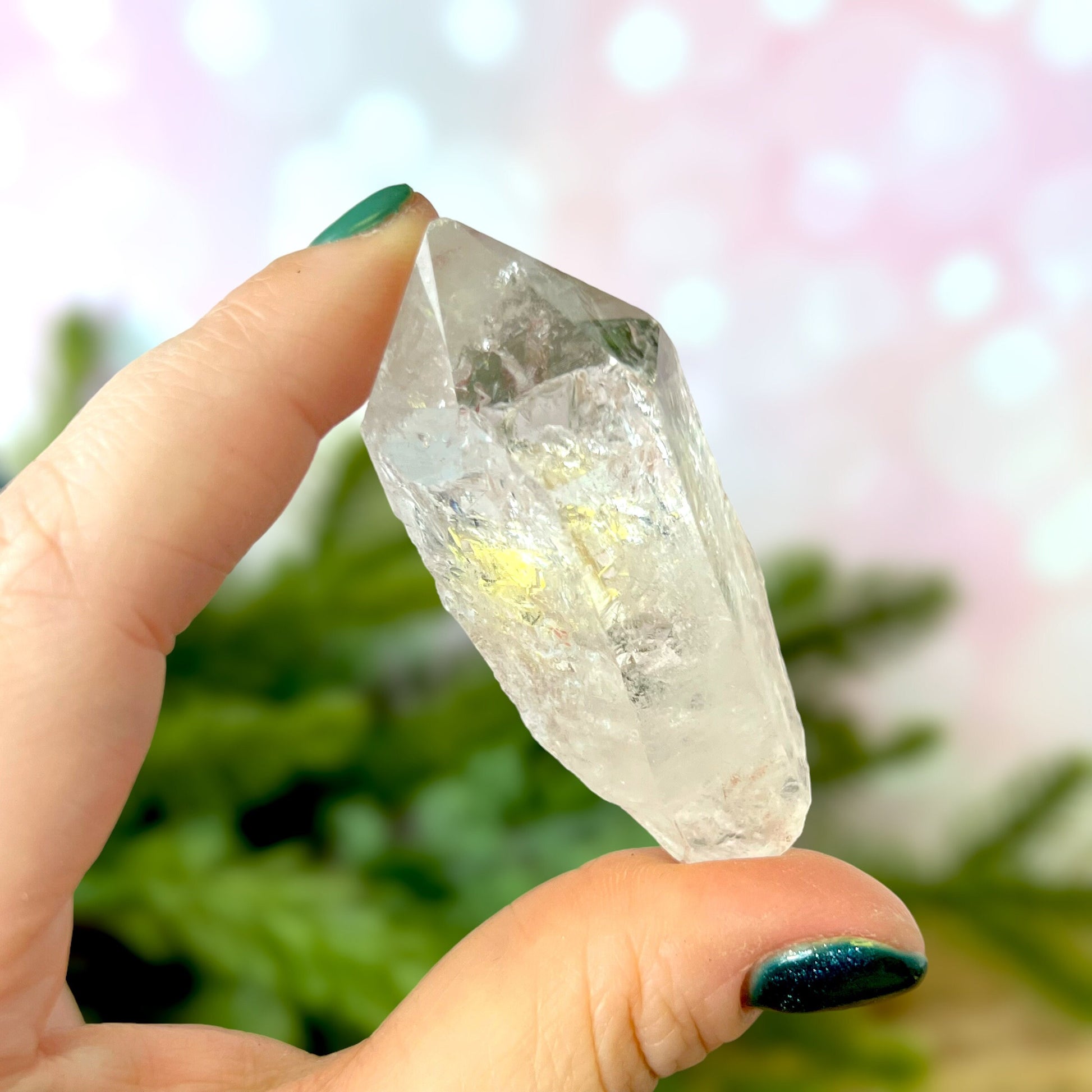 Close up of a Colombian clear Quartz crystal. It is very clear and has Lemurian horizontal lines.