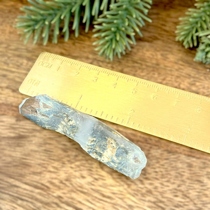 Close up of a small garden Quartz crystal point with chlorite inclusions. This mineral specimen is also called Lodolite, and is natural.