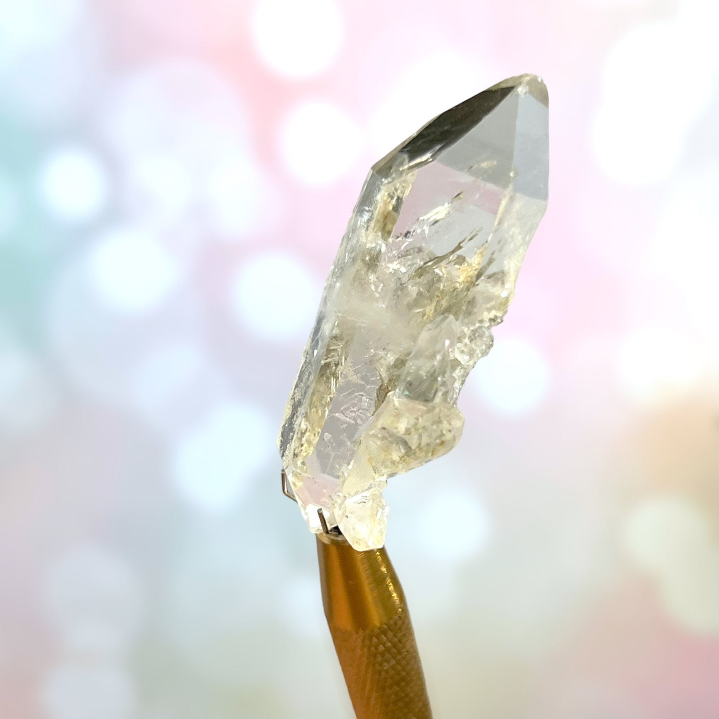 Close up of a small garden Quartz crystal point with chlorite inclusions. This mineral specimen is also called Lodolite, and is natural.