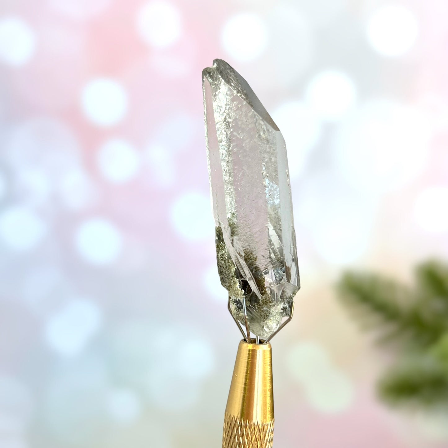 Close up of a small garden Quartz crystal point with chlorite inclusions. This mineral specimen is also called Lodolite, and is natural.