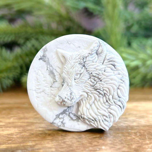 Natural and authentic Magnesite carved crystal cabochon. This Stone Cabochon has been carved into a wolf against a circular Moon.